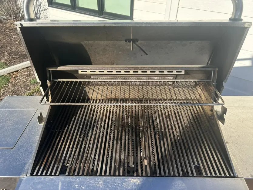 Grease and carbon buildup inside a grill before deep cleaning